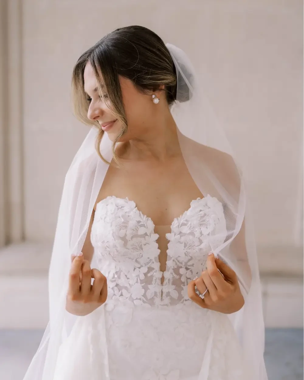 Model wearing a white bridal dress with flowers